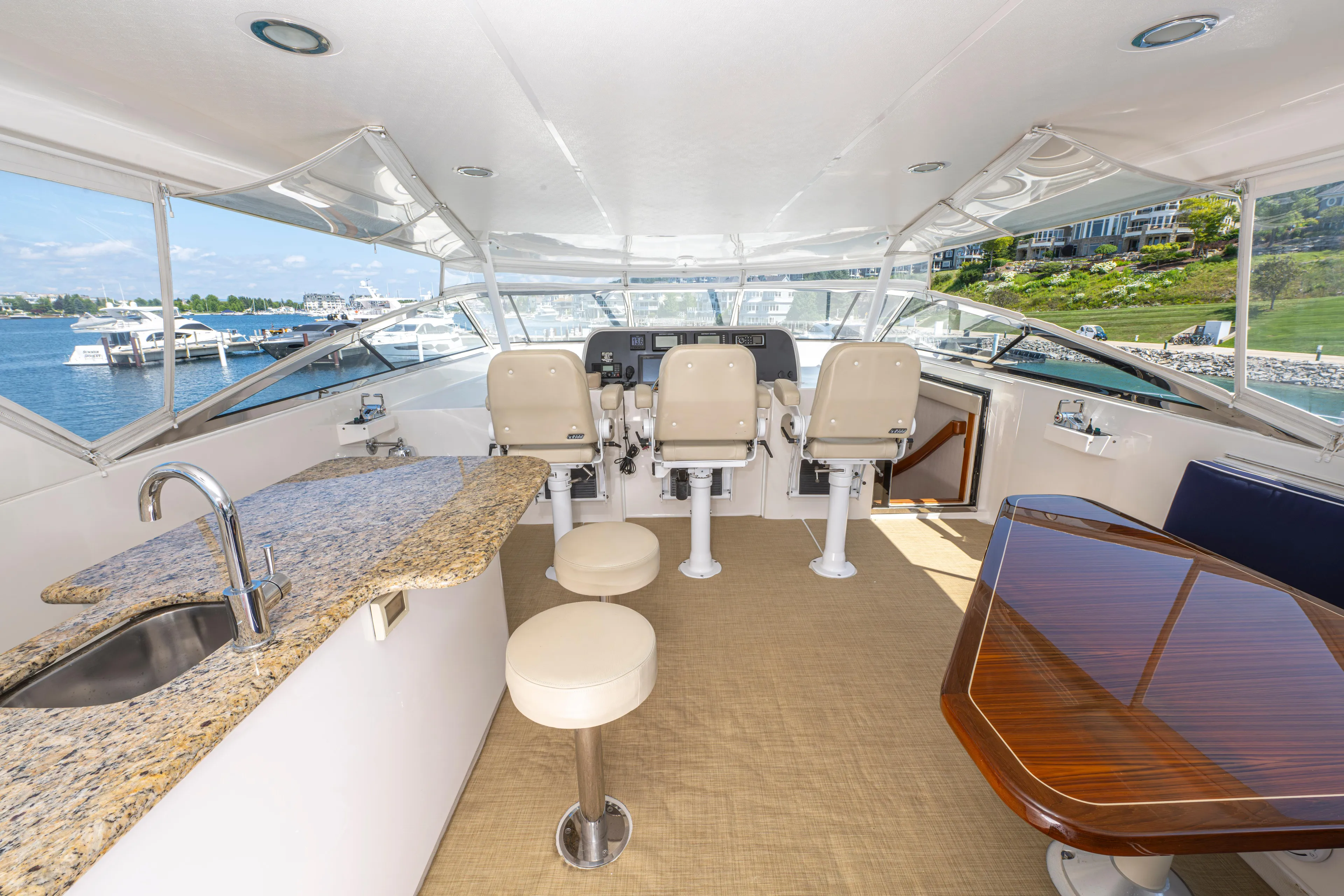  Yacht Photos Pics 2005 Pacific Mariner 85 Motor Yacht helm with granite countertop, bar stools, and panoramic views.