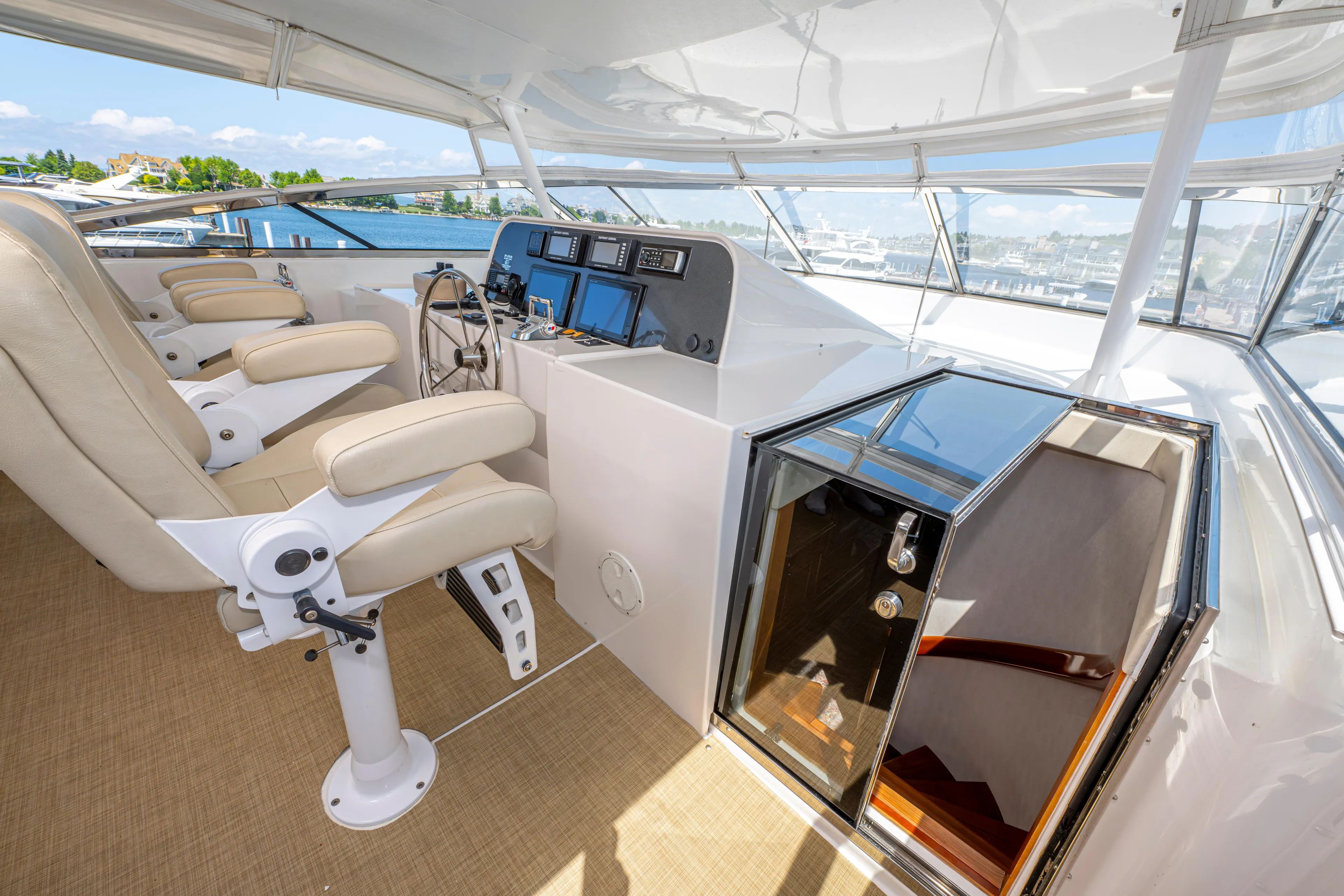  Yacht Photos Pics 2005 Pacific Mariner 85 Motor Yacht helm station with dual captain chairs and navigation equipment.