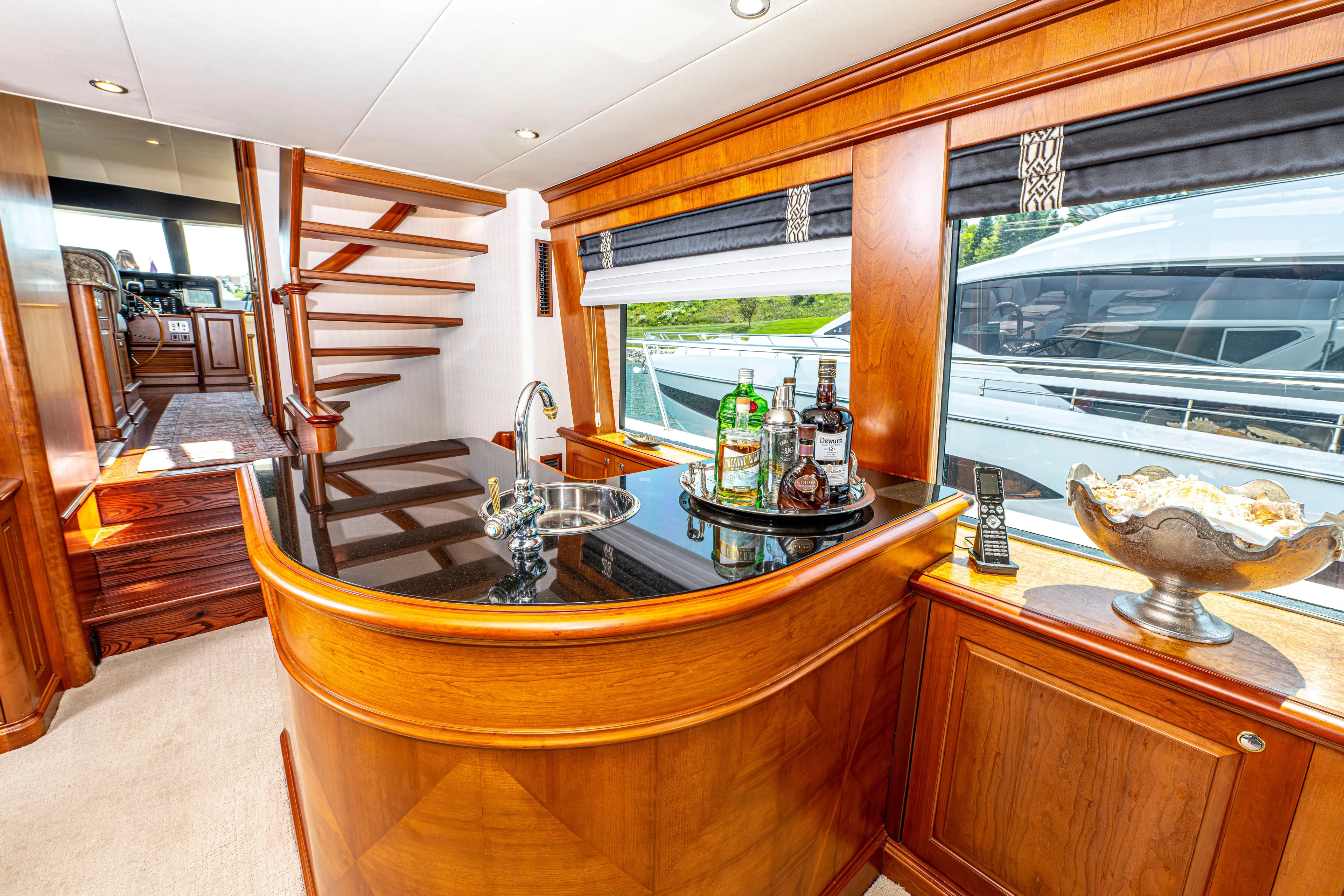  Yacht Photos Pics Luxurious interior of 2005 Pacific Mariner 85 Motor Yacht with elegant wooden bar and staircase.