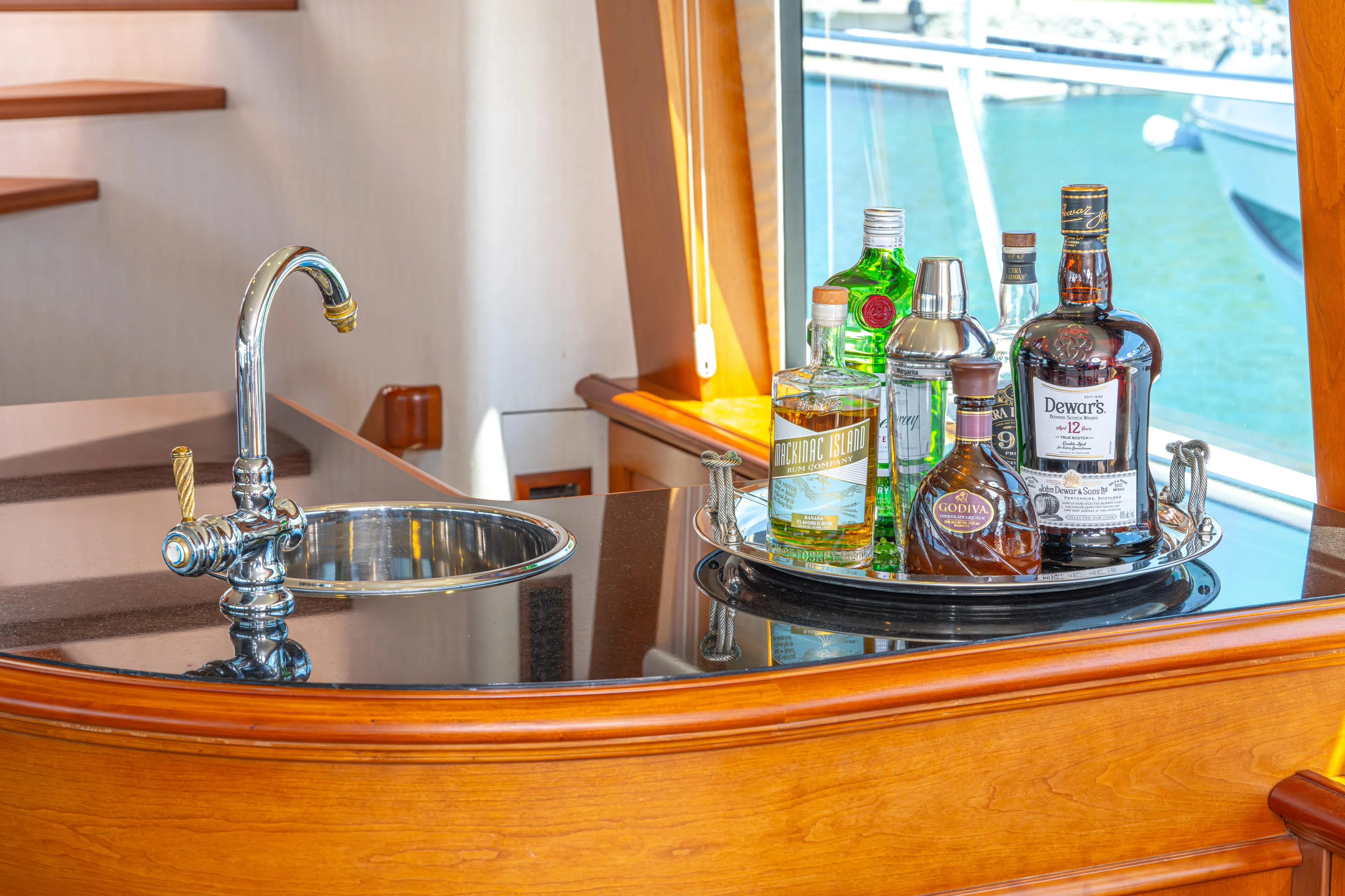  Yacht Photos Pics Bar area on a 2005 Pacific Mariner 85 Motor Yacht with liquor bottles and sink.