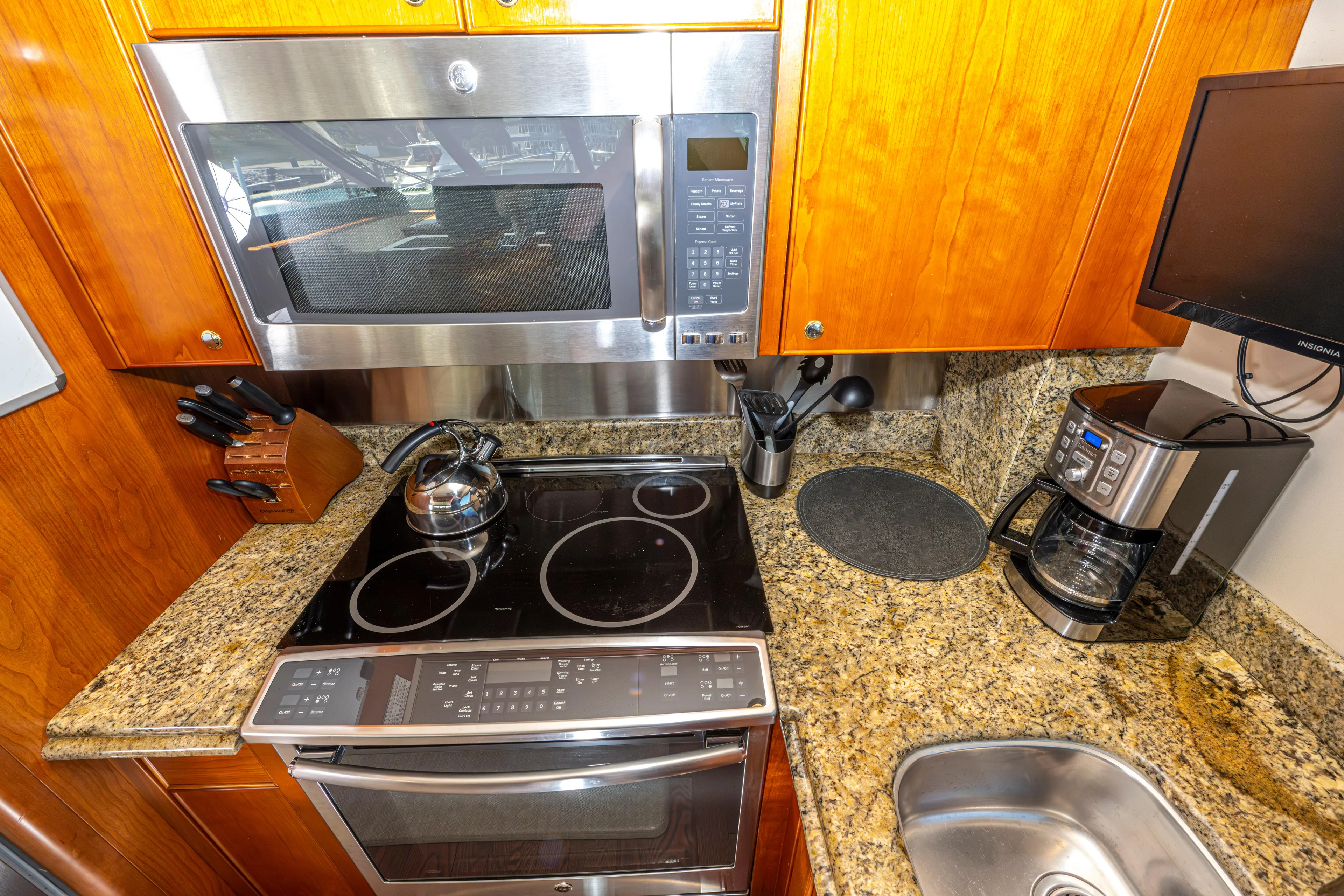  Yacht Photos Pics Galley kitchen in 2005 Pacific Mariner 85 Motor Yacht with granite countertops.