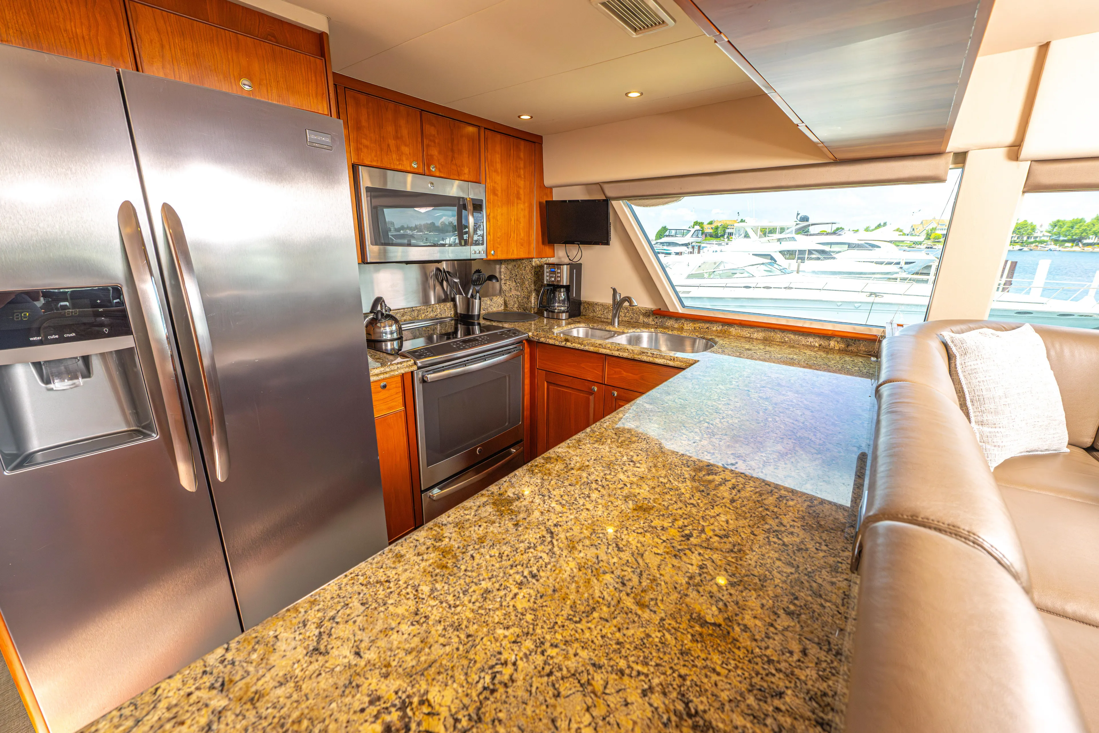  Yacht Photos Pics Luxurious kitchen in a 2005 Pacific Mariner 85 Motor Yacht with granite countertops and stainless steel appliances.