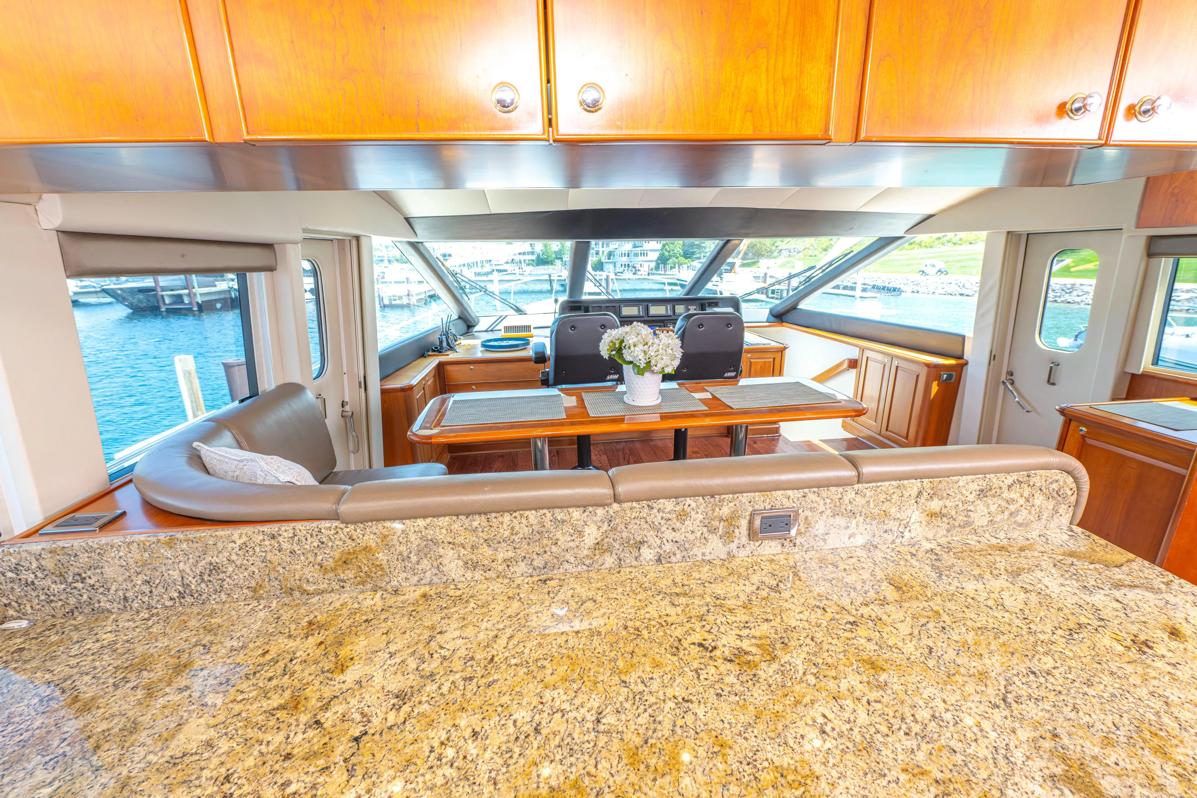  Yacht Photos Pics Interior of 2005 Pacific Mariner 85 Motor Yacht with granite countertops and dining area.