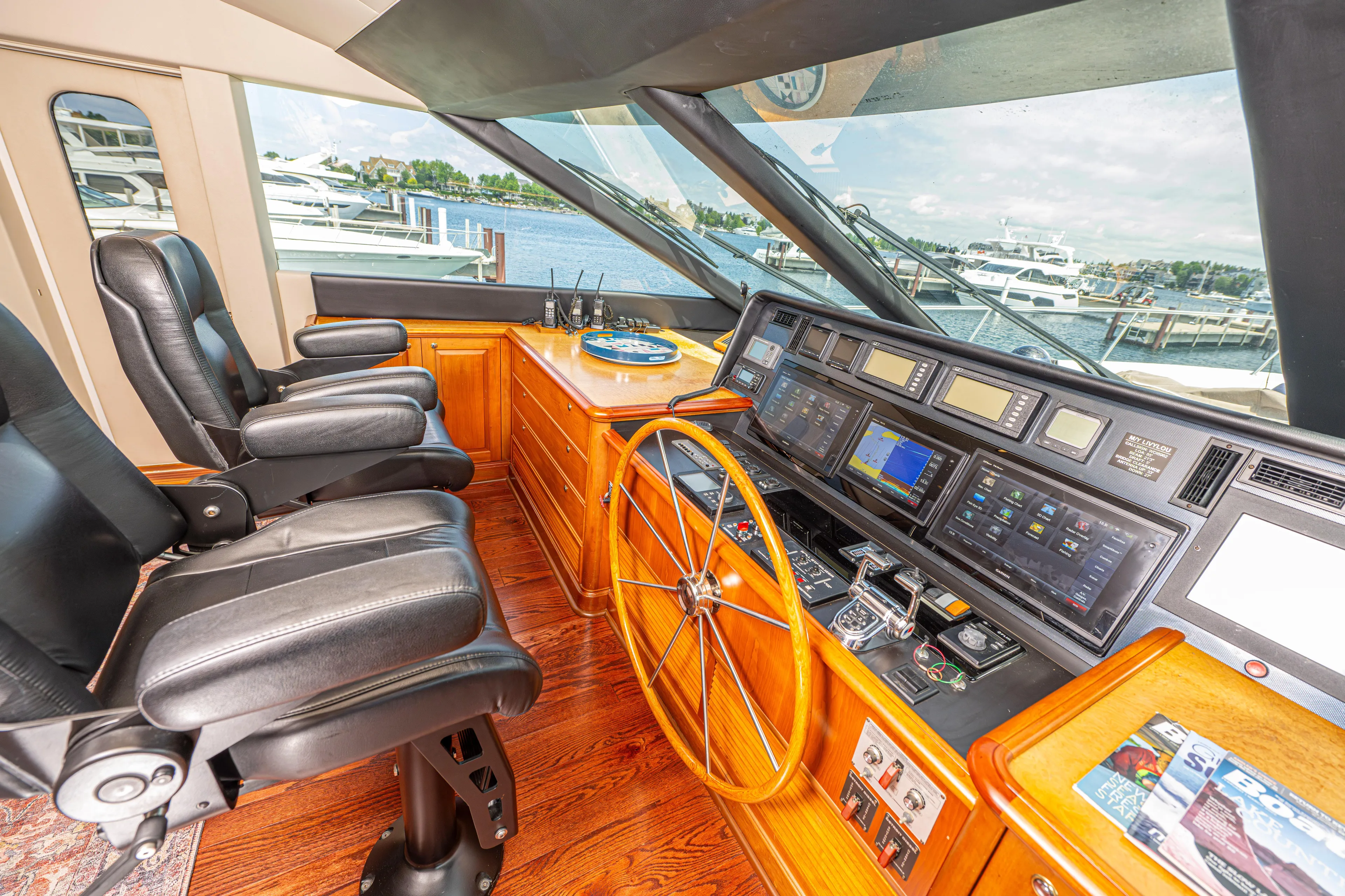  Yacht Photos Pics Helm station of 2005 Pacific Mariner 85 Motor Yacht with leather seats and advanced navigation equipment.