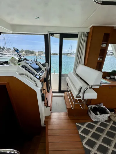  Yacht Photos Pics Interior of 2021 Beneteau Swift Trawler 41 Fly, featuring helm and seating area.