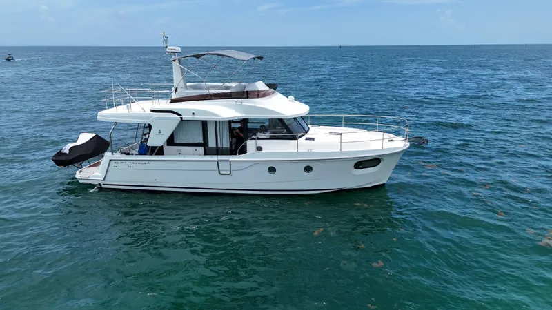  Yacht Photos Pics 2021 Beneteau Swift Trawler 41 Fly cruising on open sea.