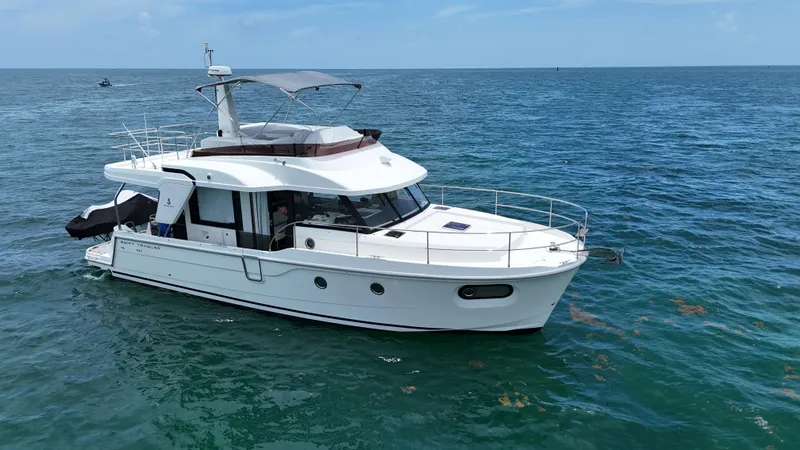  Yacht Photos Pics 2021 Beneteau Swift Trawler 41 Fly cruising on open sea under clear skies.
