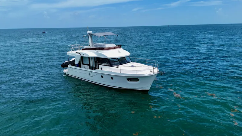  Yacht Photos Pics 2021 Beneteau Swift Trawler 41 Fly cruising on open sea under clear skies.