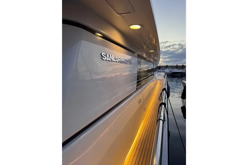  Yacht Photos Pics Sanlorenzo SL88 yacht, 2000 model, docked at sunset with illuminated deck.