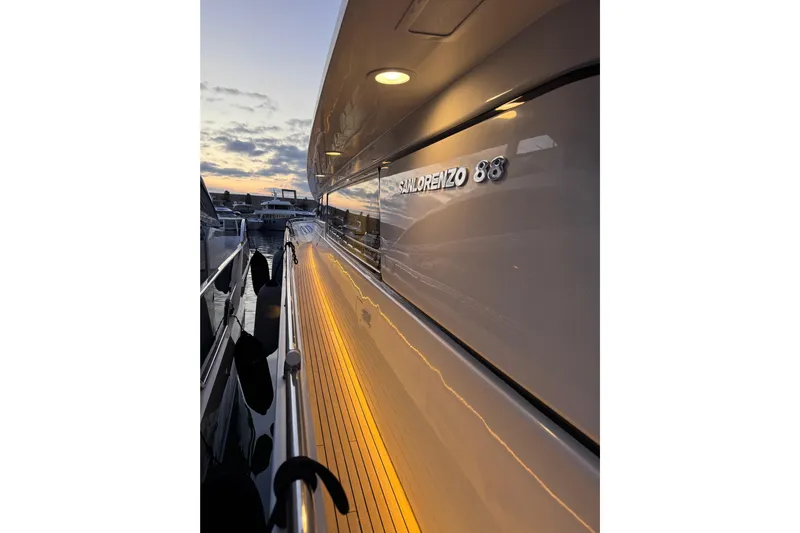  Yacht Photos Pics Sanlorenzo SL88 yacht, 2000 model, docked at sunset with illuminated deck.