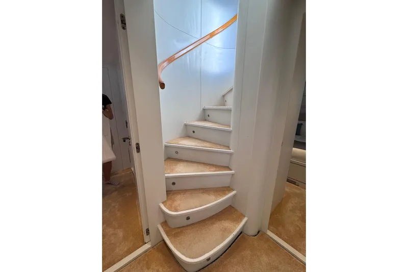  Yacht Photos Pics Curved staircase with beige carpet on Sanlorenzo SL88 yacht, 2000 model.