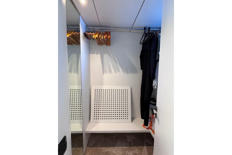  Yacht Photos Pics Modern closet interior on Sanlorenzo SL88 yacht, featuring hangers and shelving, 2000 model.