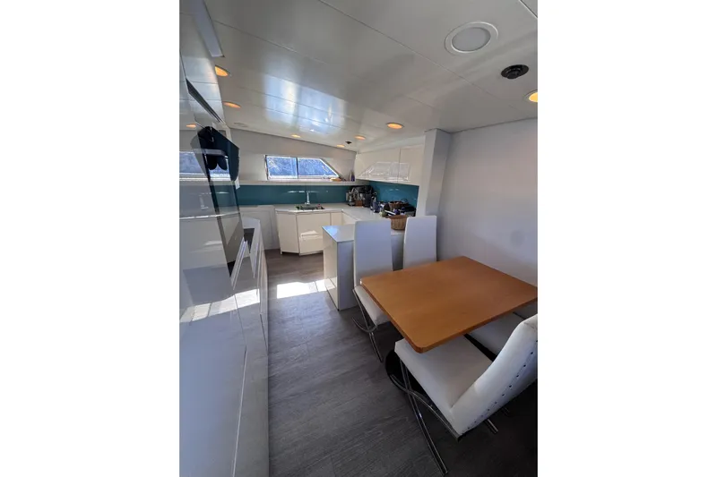  Yacht Photos Pics Modern kitchen and dining area inside 2000 Sanlorenzo SL88 yacht, featuring sleek design and natural lighting.