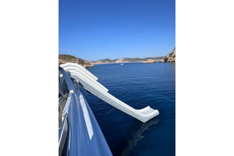  Yacht Photos Pics Sanlorenzo SL88 yacht with slide, anchored in scenic coastal waters, 2000 model.