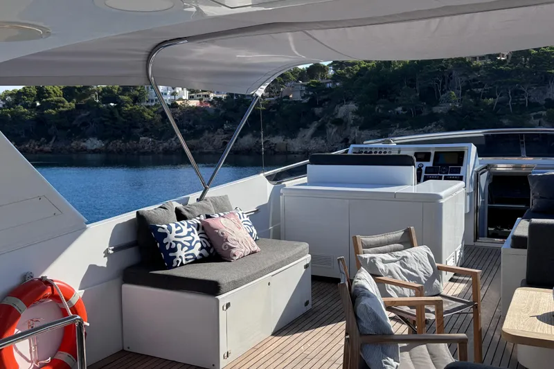  Yacht Photos Pics Luxurious Sanlorenzo SL88 yacht deck with seating, cushions, and scenic coastal view.
