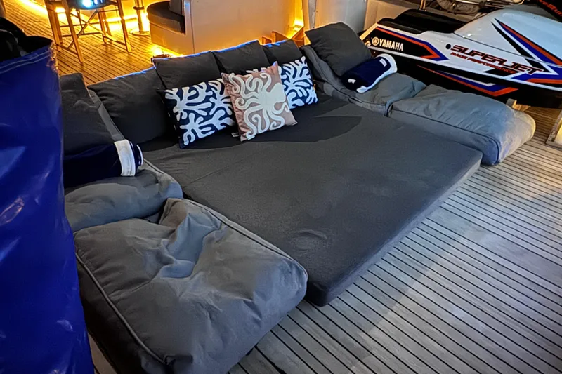  Yacht Photos Pics Luxurious Sanlorenzo SL88 yacht interior with cozy seating and decorative pillows, featuring a Yamaha SuperJet.