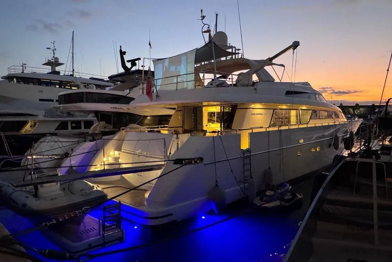  Yacht Photos Pics Sanlorenzo SL88 yacht from 2000 docked at sunset with illuminated deck.