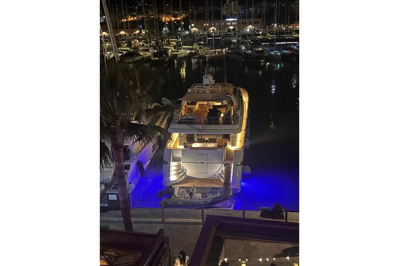  Yacht Photos Pics Sanlorenzo SL88 yacht docked at night, illuminated with blue underwater lights.