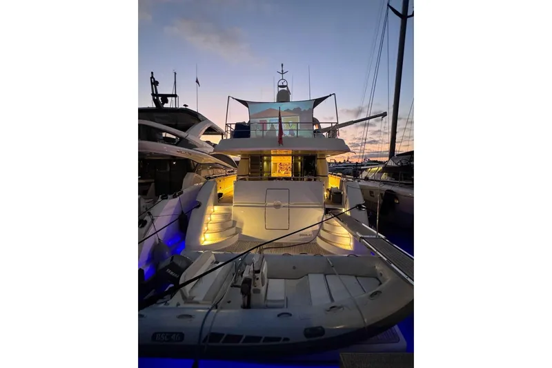  Yacht Photos Pics Luxurious 2000 Sanlorenzo SL88 yacht docked at sunset with illuminated deck.