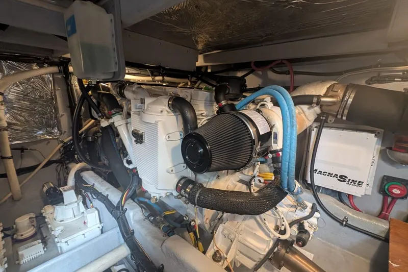 High Flyer Yacht Photos Pics Engine room of a 2007 Meridian 411 Sedan Bridge yacht, showcasing mechanical components.