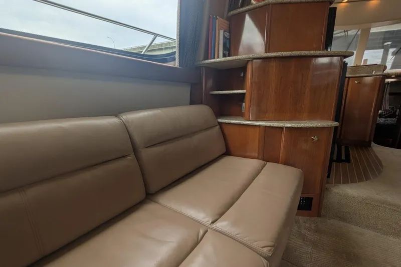 High Flyer Yacht Photos Pics Luxurious interior of 2007 Meridian 411 Sedan Bridge with leather seating and wooden cabinetry.