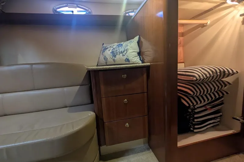 High Flyer Yacht Photos Pics Interior of 2007 Meridian 411 Sedan Bridge with seating, drawers, and striped cushions.