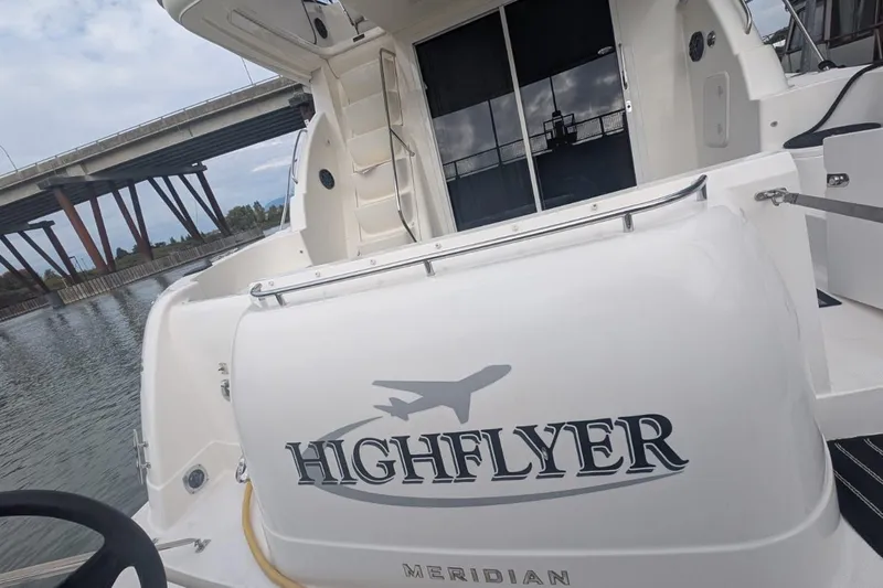 High Flyer Yacht Photos Pics 2007 Meridian 411 Sedan Bridge yacht named "Highflyer" docked near a bridge.