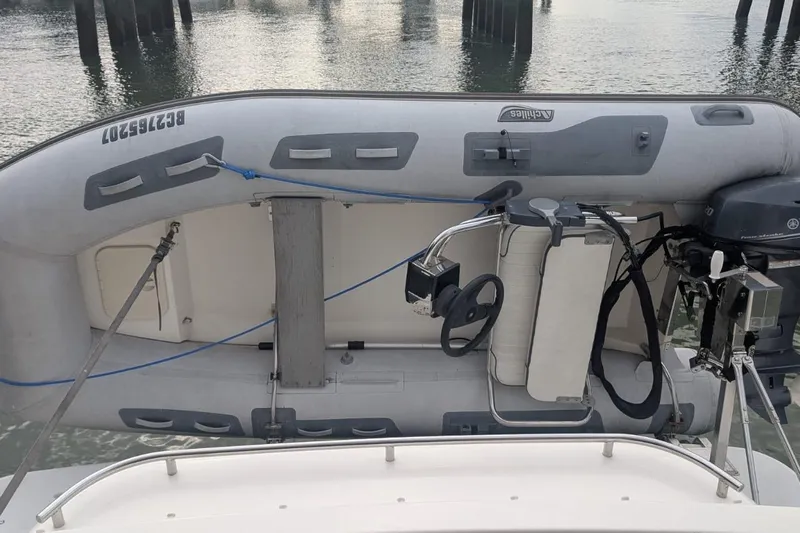 High Flyer Yacht Photos Pics 2007 Meridian 411 Sedan Bridge with inflatable dinghy and outboard motor on deck.