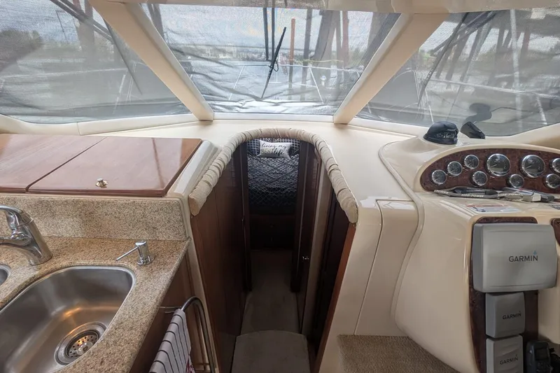 High Flyer Yacht Photos Pics 2007 Meridian 411 Sedan Bridge interior with kitchen sink, control panel, and cabin entrance.