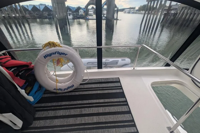 High Flyer Yacht Photos Pics 2007 Meridian 411 Sedan Bridge deck with life ring and scenic marina view.