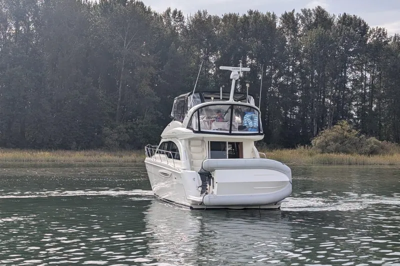High Flyer Yacht Photos Pics 2007 Meridian 411 Sedan Bridge yacht cruising on a serene lake with forest backdrop.