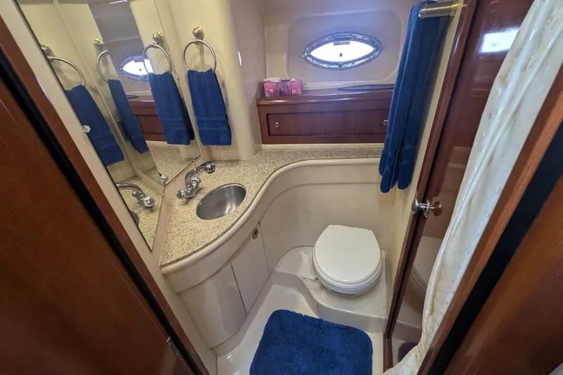 High Flyer Yacht Photos Pics Luxurious bathroom in 2007 Meridian 411 Sedan Bridge yacht, featuring elegant fixtures and blue accents.