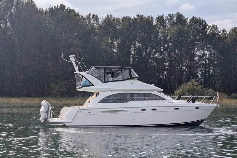 High Flyer Yacht Photos Pics 2007 Meridian 411 Sedan Bridge yacht on calm water with forest backdrop.