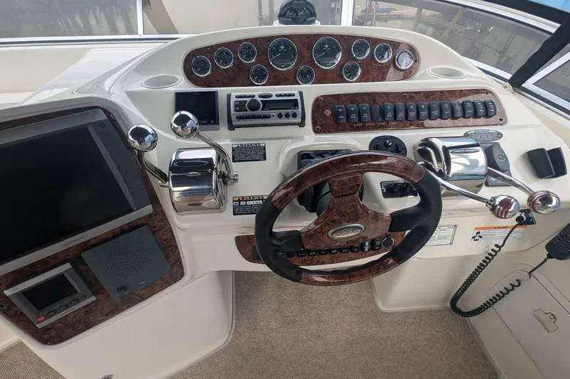 High Flyer Yacht Photos Pics 2007 Meridian 411 Sedan Bridge helm with wood accents and modern navigation controls.