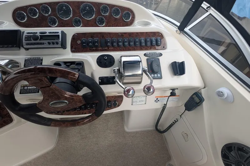 High Flyer Yacht Photos Pics 2007 Meridian 411 Sedan Bridge helm with wood accents and navigation controls.
