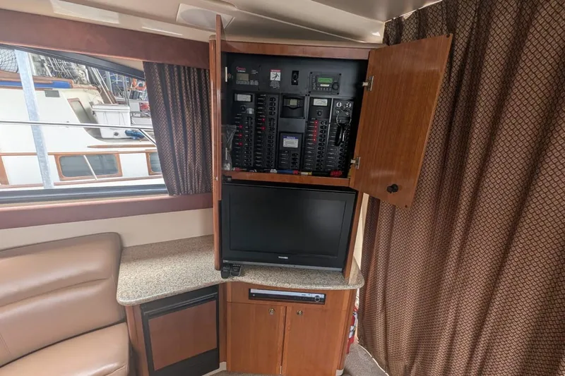 High Flyer Yacht Photos Pics 2007 Meridian 411 Sedan Bridge interior with control panel and TV setup.