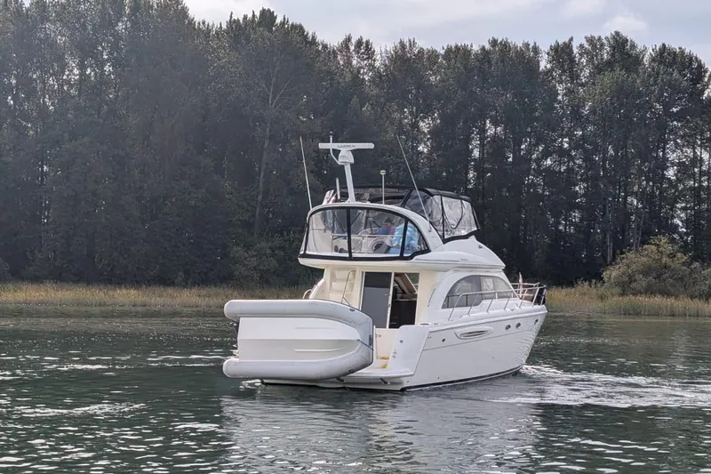 High Flyer Yacht Photos Pics 2007 Meridian 411 Sedan Bridge yacht cruising on a serene lake with forest backdrop.