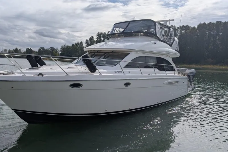 High Flyer Yacht Photos Pics 2007 Meridian 411 Sedan Bridge yacht on calm water, overcast sky.
