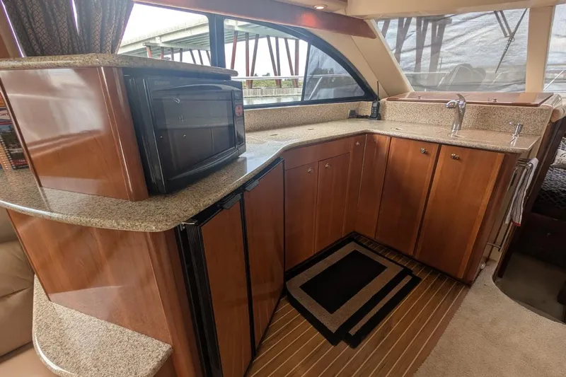 High Flyer Yacht Photos Pics Luxurious 2007 Meridian 411 Sedan Bridge yacht interior with modern kitchen amenities.