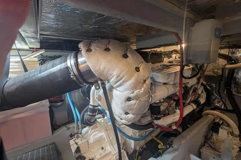 High Flyer Yacht Photos Pics Engine room of a 2007 Meridian 411 Sedan Bridge, showcasing insulated components and piping.