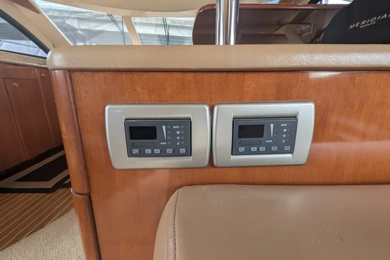 High Flyer Yacht Photos Pics 2007 Meridian 411 Sedan Bridge interior with dual control panels on wooden surface.