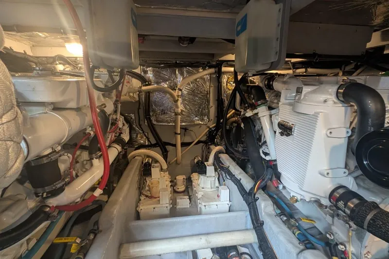 High Flyer Yacht Photos Pics Engine room of a 2007 Meridian 411 Sedan Bridge yacht, showcasing mechanical components.