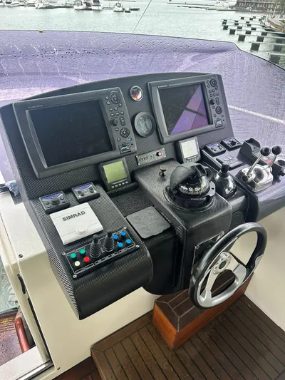  Yacht Photos Pics 2009 Conam 65 Flybridge helm with advanced navigation and control systems.