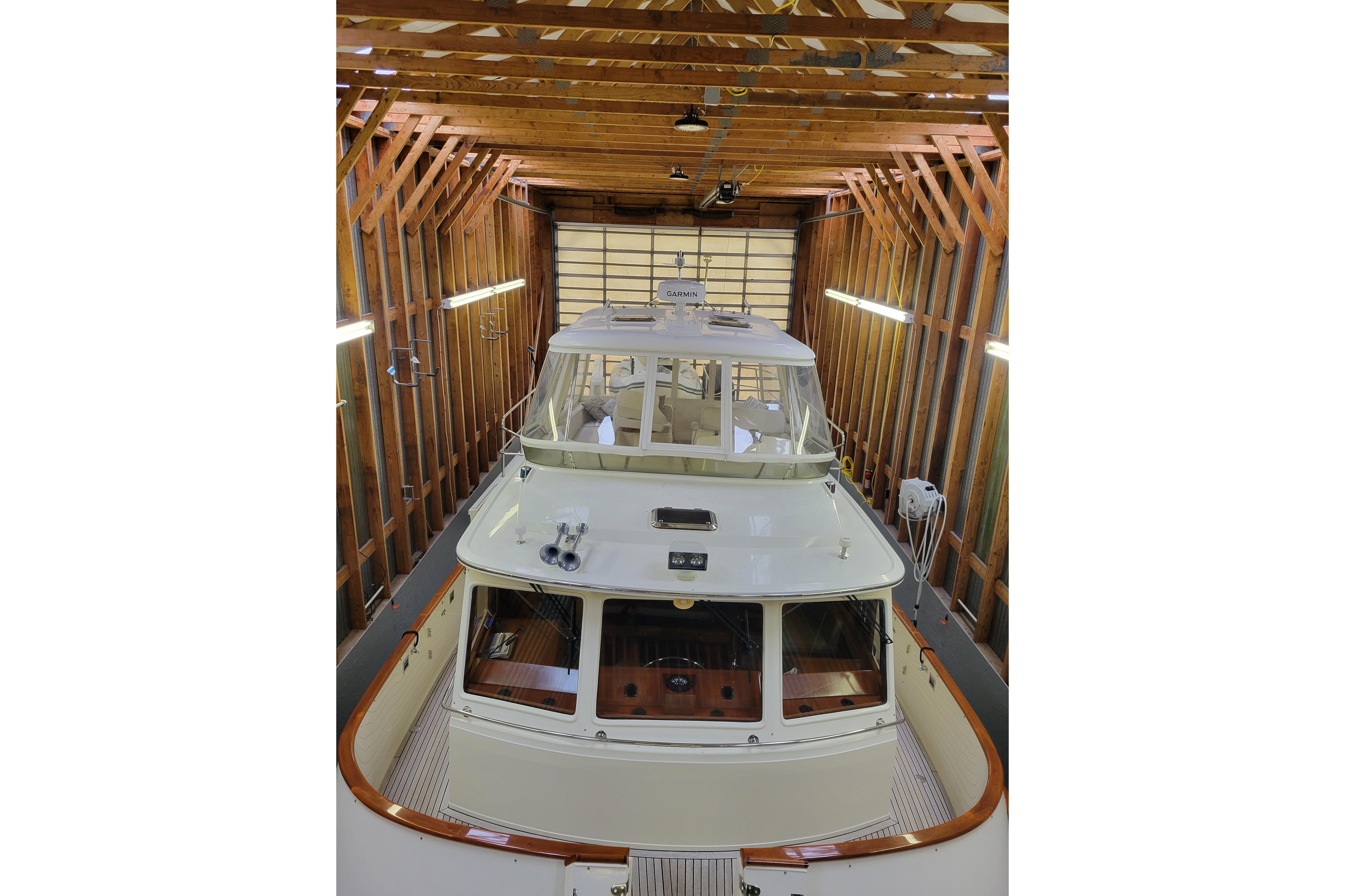 2009 Fleming Pilothouse yacht in wooden boathouse, top view.