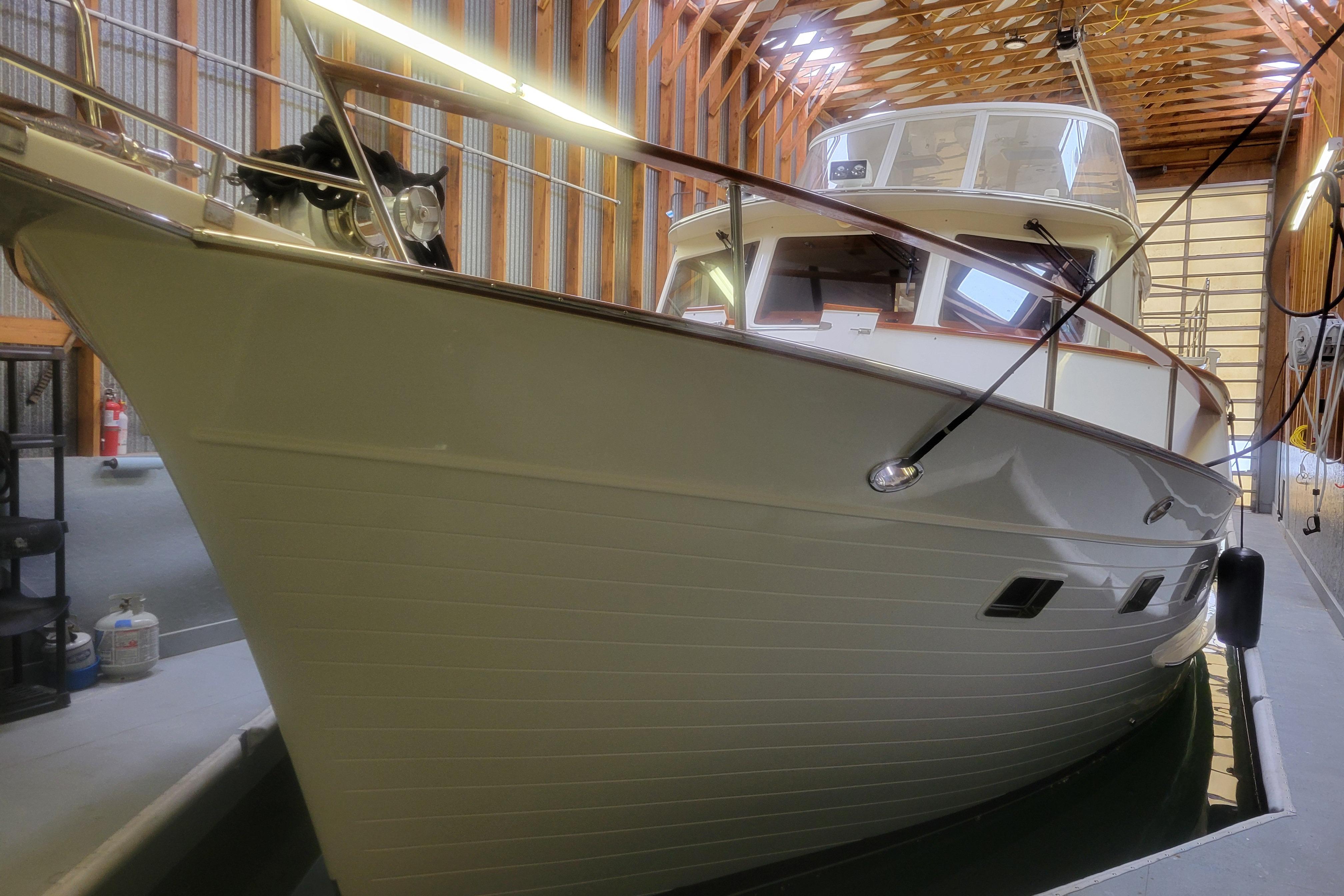 2009 Fleming Pilothouse yacht docked in a wooden boathouse.