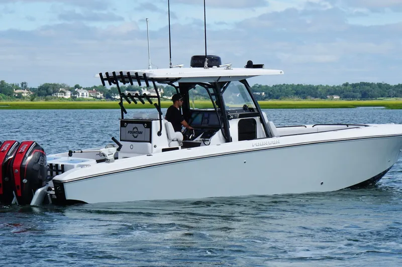  Yacht Photos Pics 2024 Fountain 34 TE boat cruising on a calm lake with dual engines.