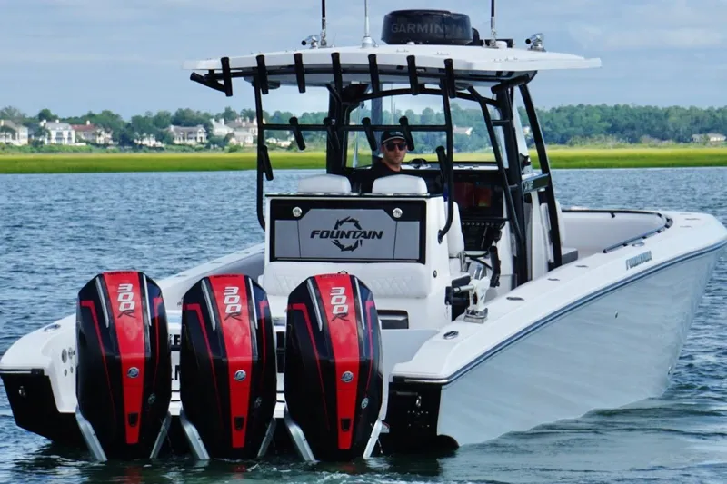  Yacht Photos Pics 2024 Fountain 34 TE boat with triple 300R engines on a scenic waterway.