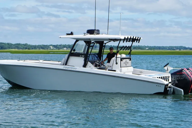  Yacht Photos Pics 2024 Fountain 34 TE boat on water, featuring dual outboard engines.