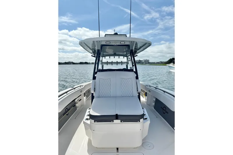  Yacht Photos Pics 2024 Fountain 34 TE boat on water, featuring sleek seating and modern design.