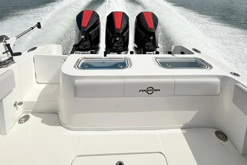  Yacht Photos Pics 2024 Fountain 34 TE boat with triple outboard engines on water.